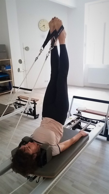 a man performing long spine exercise on Pialtes Reformer