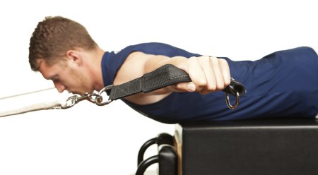 a man performing reformer exercise