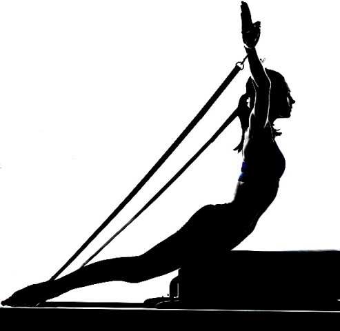 a woman performing back exercise on Pilates Reformer